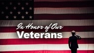 A silhouette of a solider next to the words In Honor of Our Veterans with an American Flag as the background.
