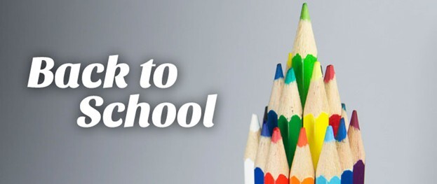 The words back to school next to a tree made of colored pencils.
