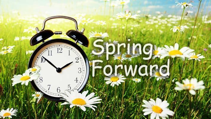 The words Spring Forward with a clock in a field of white flowers.